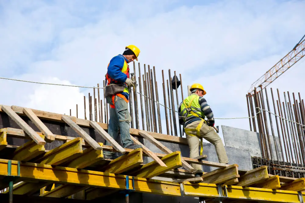 Expert roofers installing metal roofing on a building site